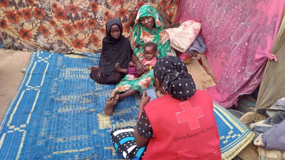 A mother and her two children who have fled conflict in Sudan and are seeking refuge in Chad.